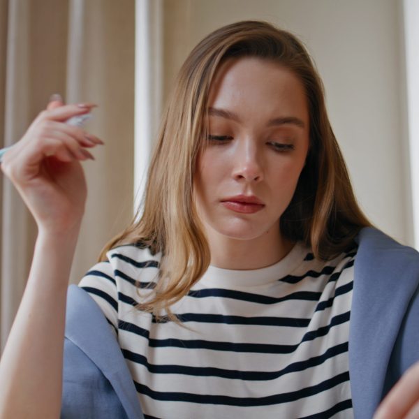 businesswoman-working-with-documents-in-office-environment-closeup-remote-employee-rev-SBI-350942839